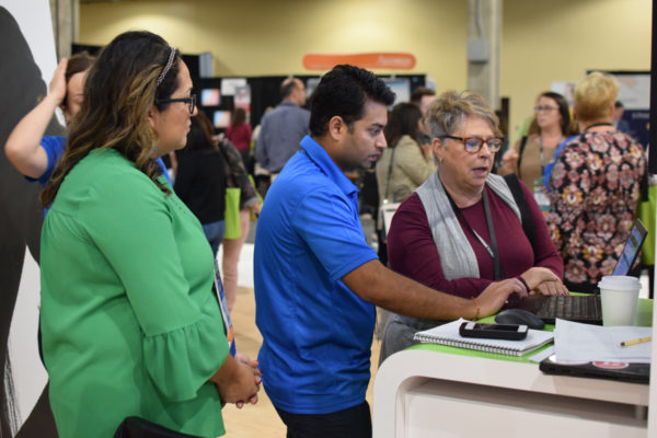 Summit 2019 Attendees being shown product by a staff member