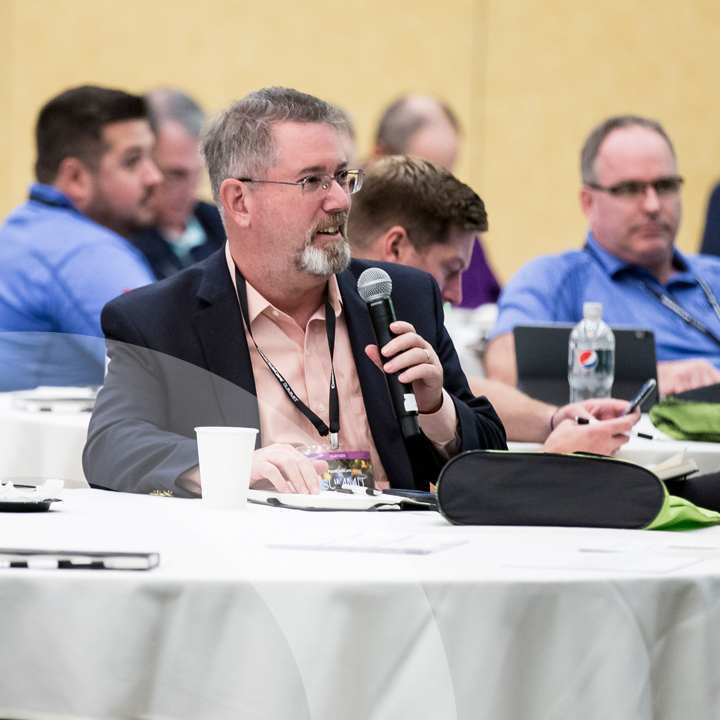Summit partner asking a question at conference